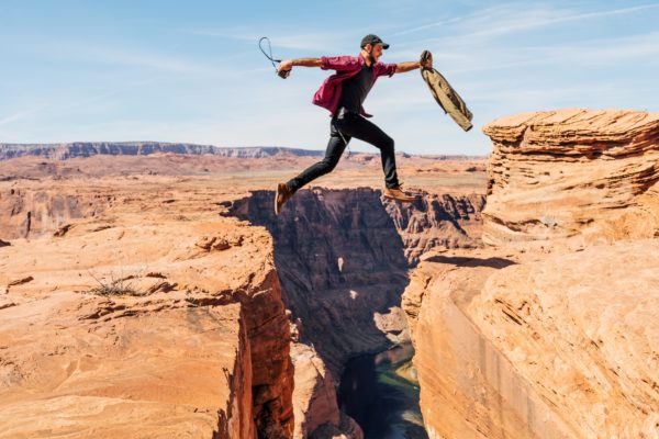 Man leaping over a rocky gorge