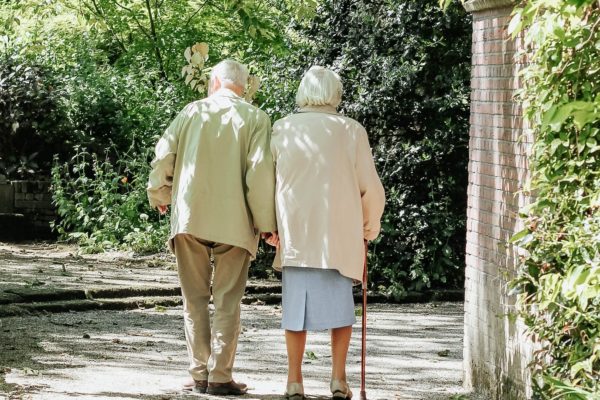 A senior couple walking down a quiet lane