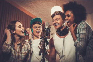 Singers gather around a microphone.
