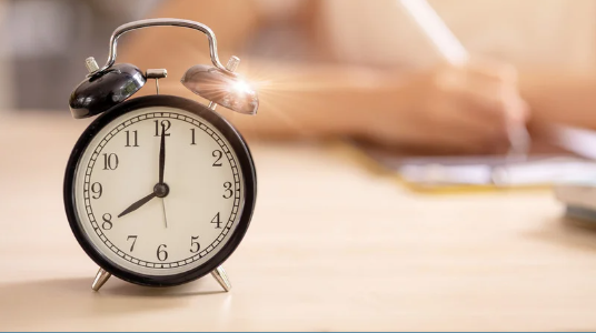 A clock on a desk.