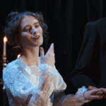 A young actress sings onstage.