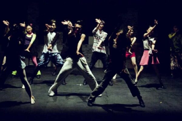 A group of young men dance hip hop.