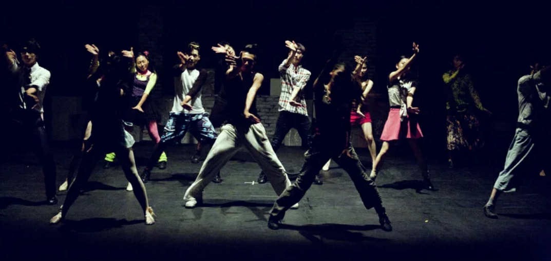 A group of young men dance hip hop.