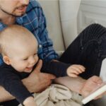 A father and child read a book.